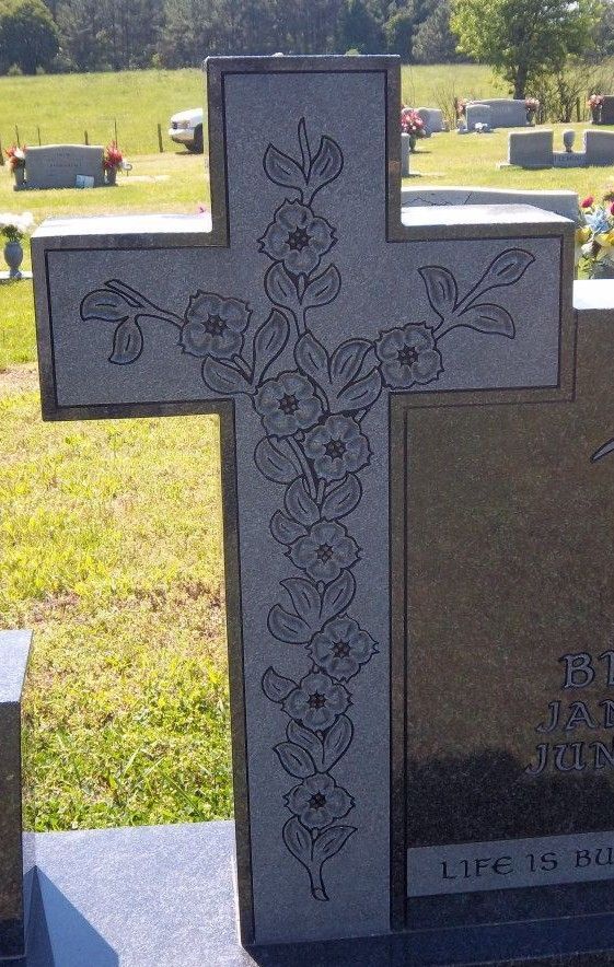 Gravestone with etched design of a boy fishing with a dog,