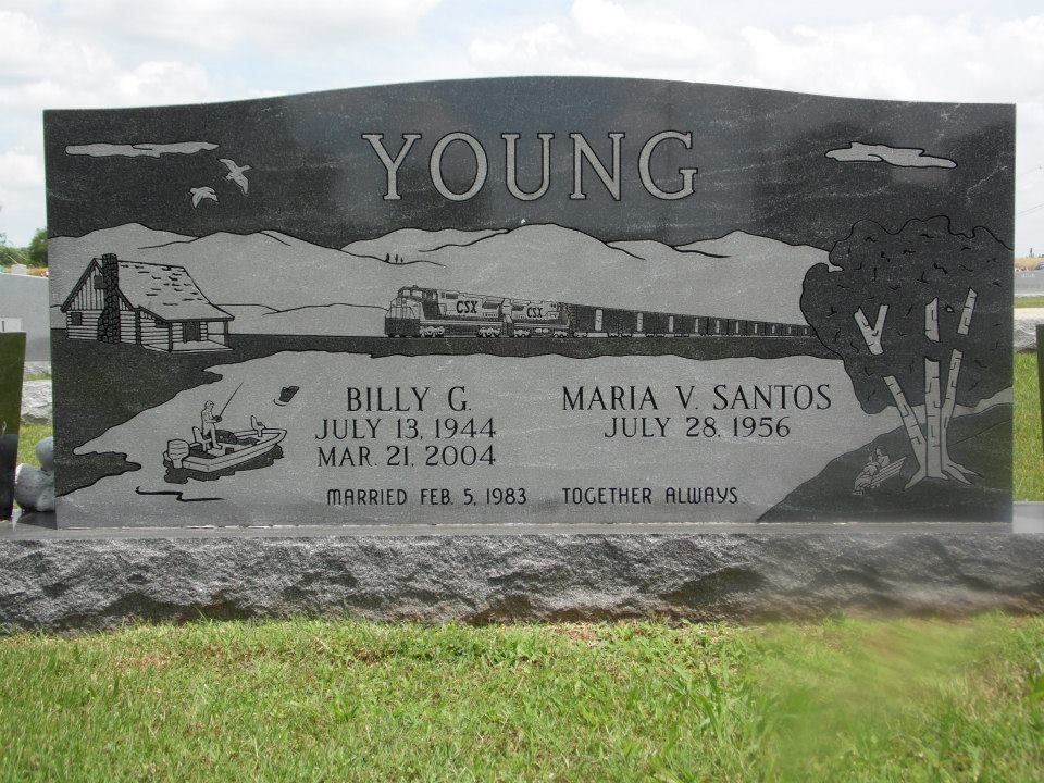 Black headstone with landscape painting: cabin, deer, sunrise, name, and dates.