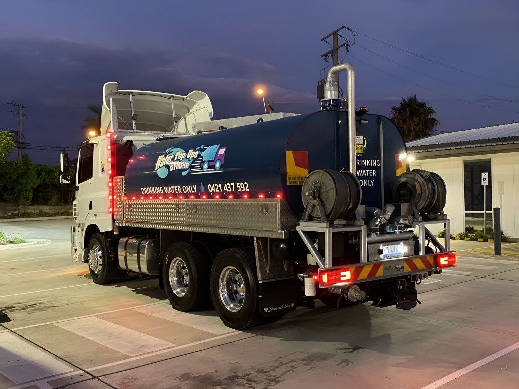 A Large Tanker Truck is Parked in a Parking Lot at Night — Water TopUps Gympie in Curra, QLD