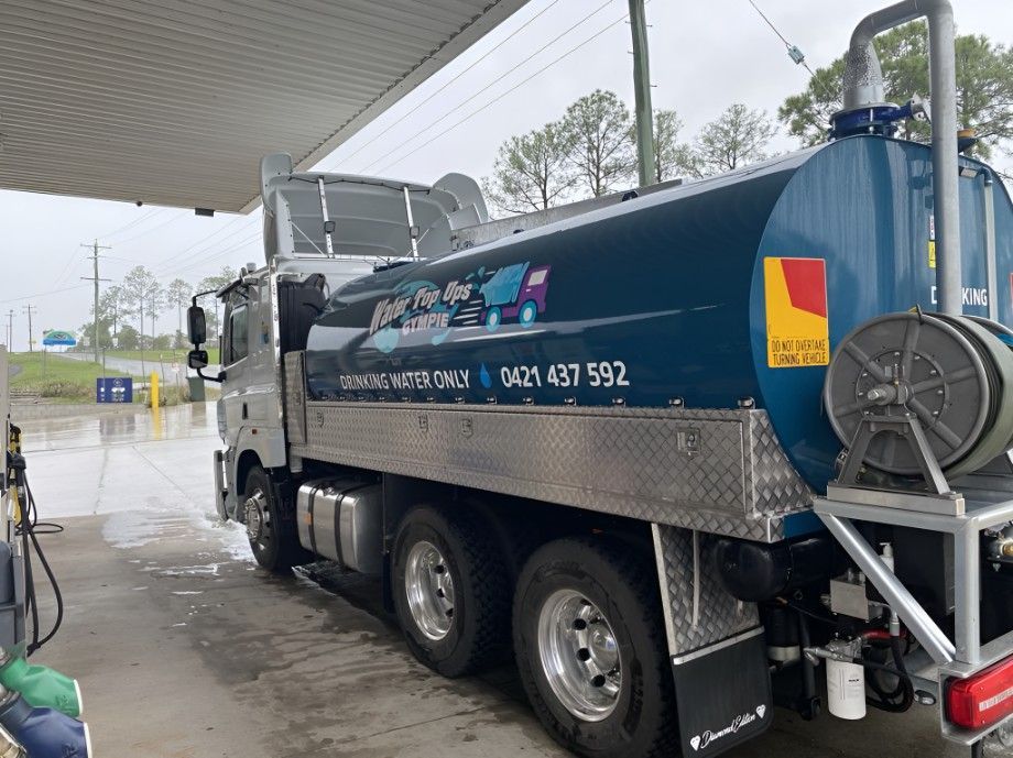 Water Tanker Truck at a Gas Station, Dark Teal Tank — Water TopUps Gympie in Curra, QLD