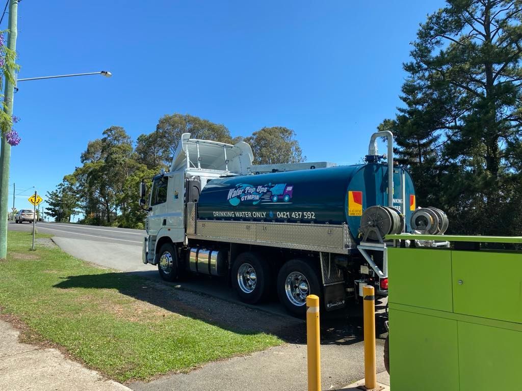 Blue water tanker truck parked on roadside, sunny day. — Water TopUps Gympie in Chatsworth, QLD