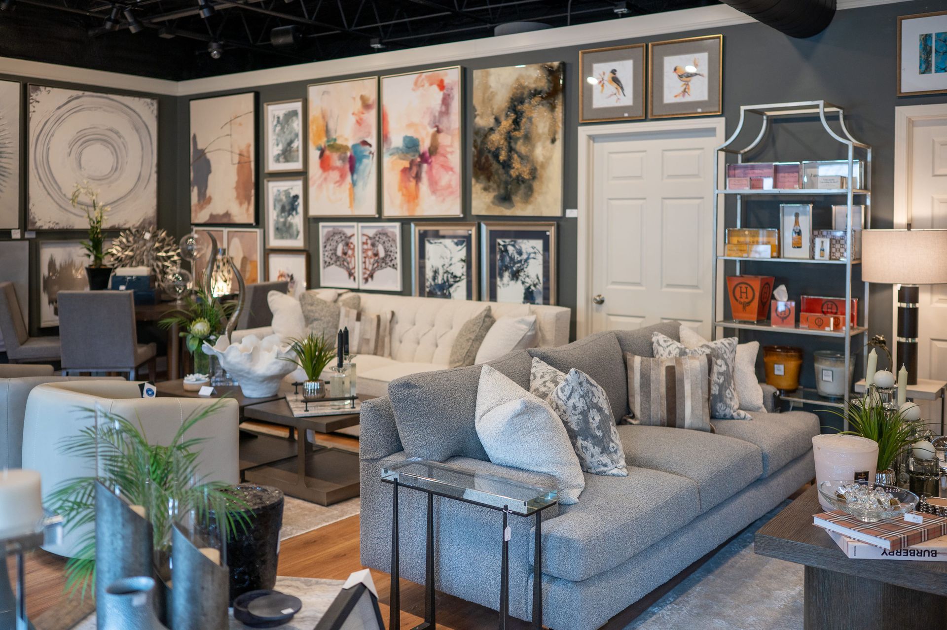 Interior of a furniture store with sofas, art, and decor displayed on the walls.