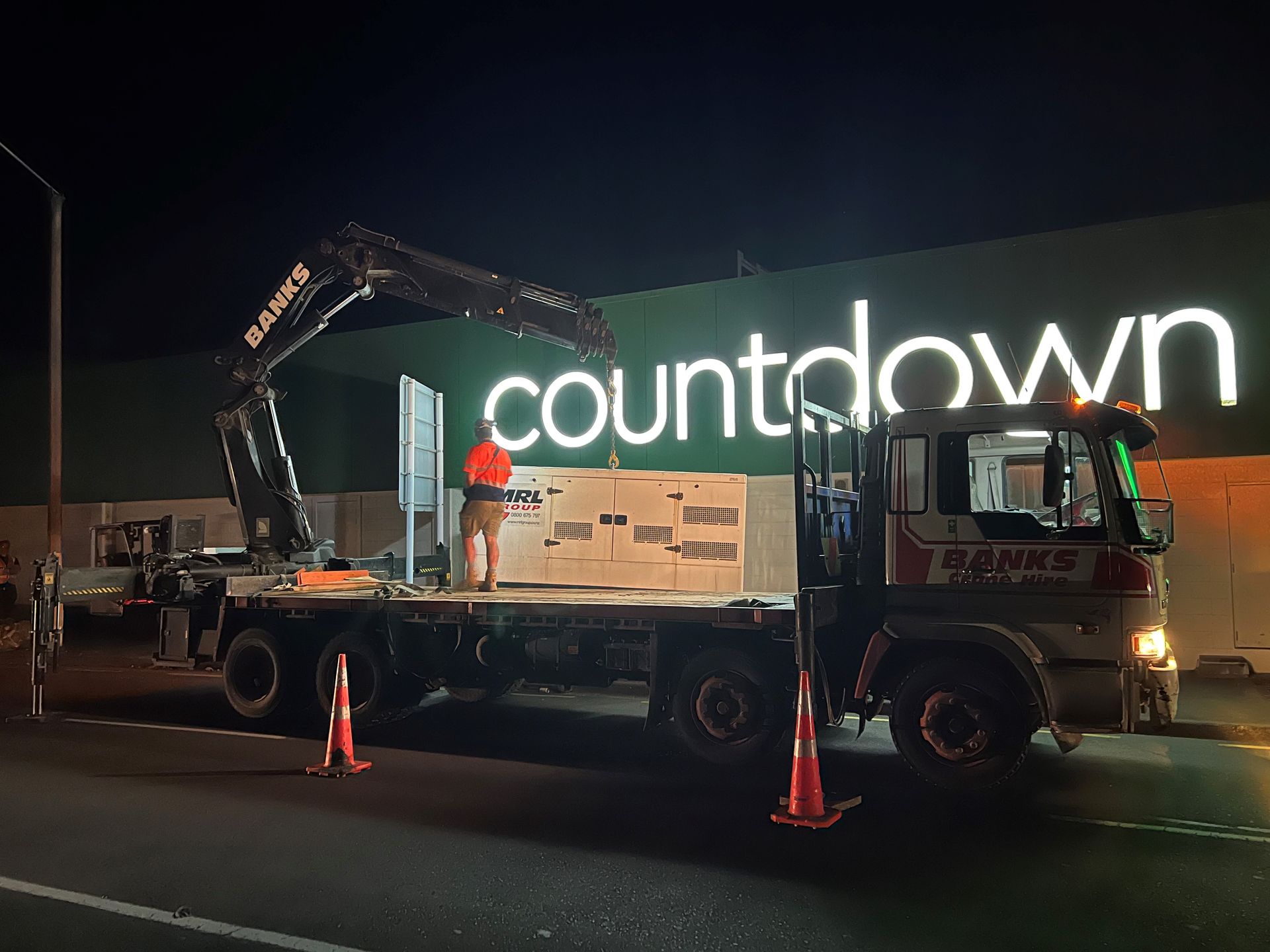 A truck is parked in front of a building that says countdown.