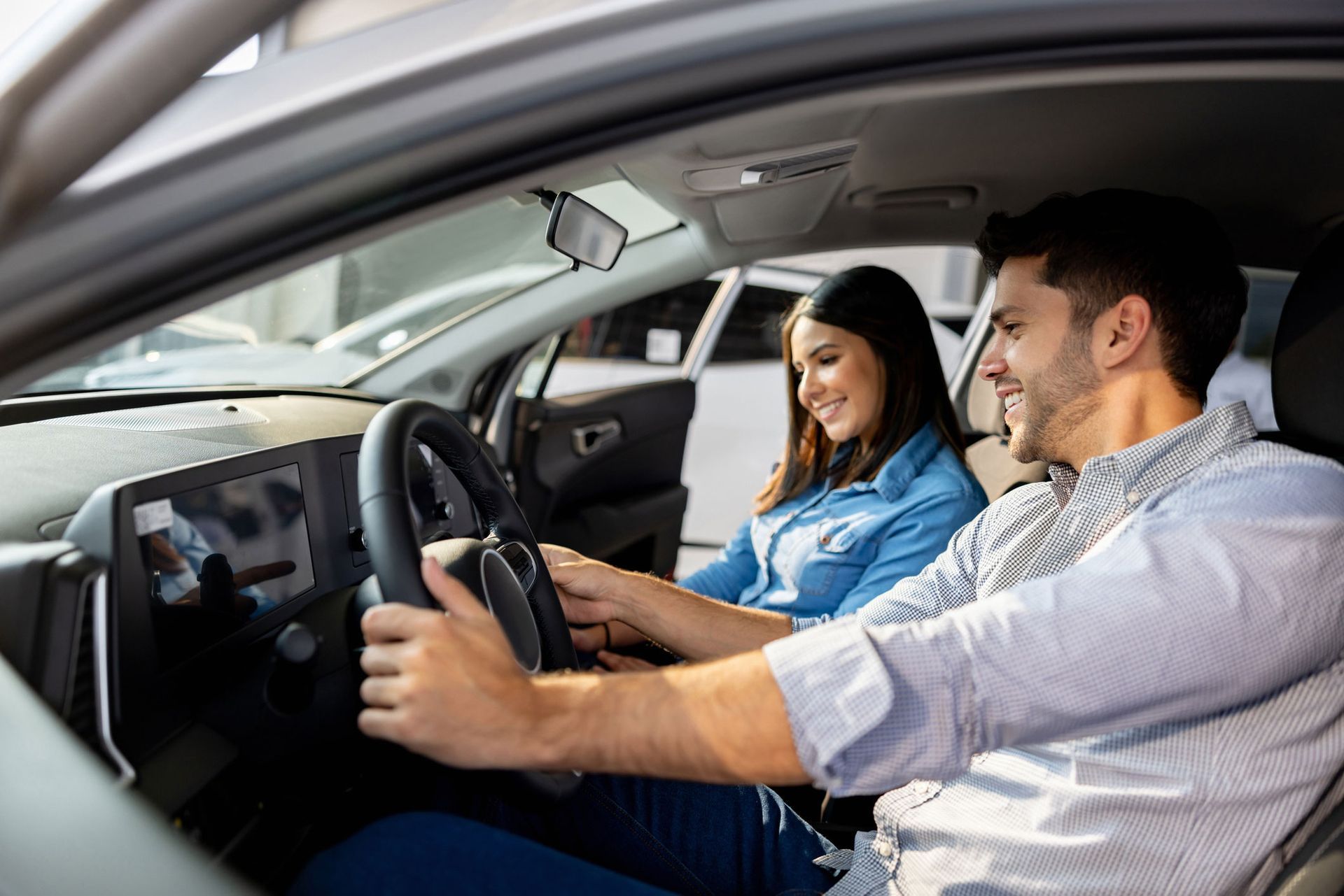 A Man And A Woman Sitting In A Car — Thornton, CO — Thornton Westminster Locksmith