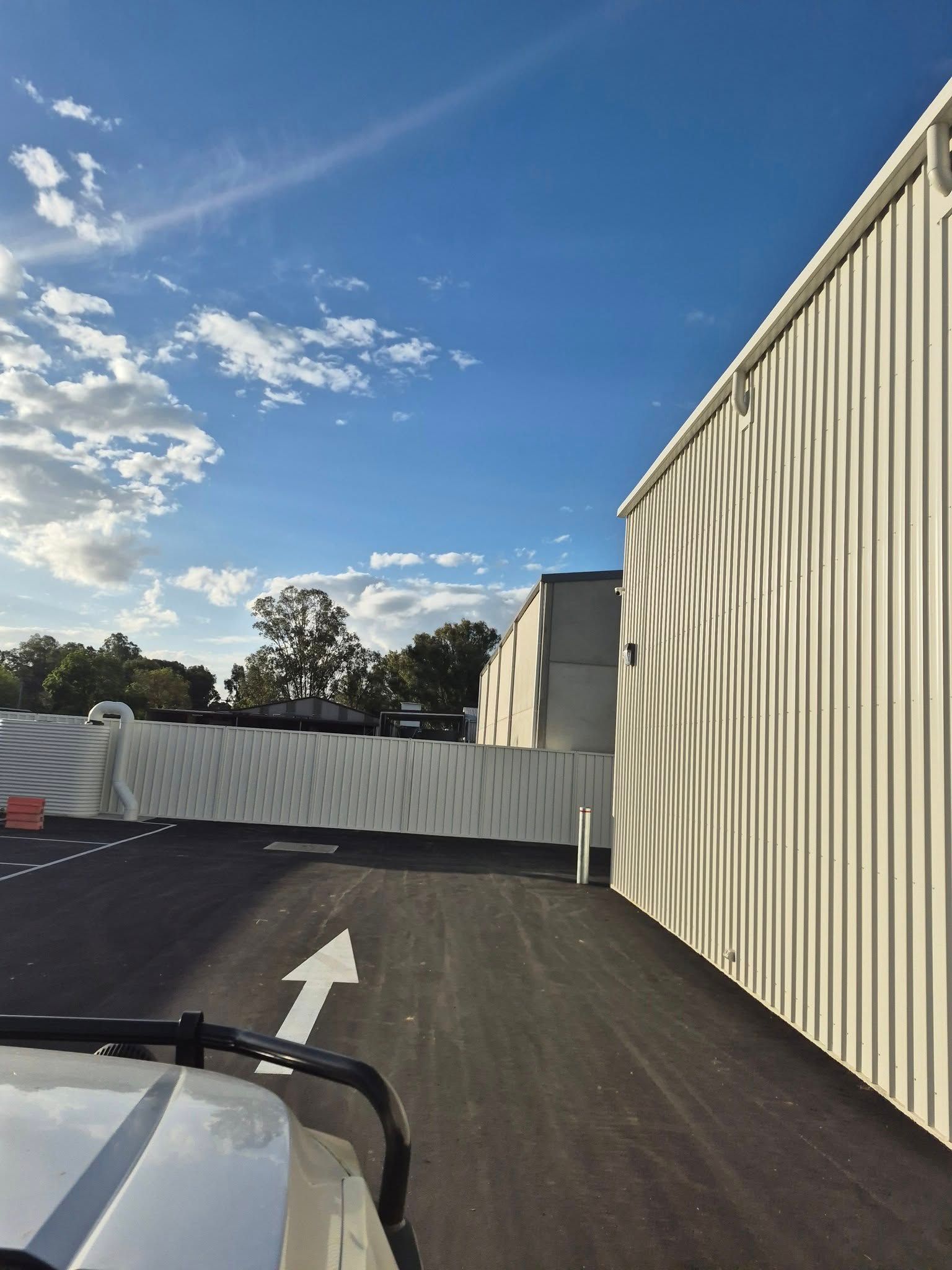 Exterior View of Asphalt Driveway, and White Fence — Precision Fencing & Landscaping in Wagga Wagga, NSW