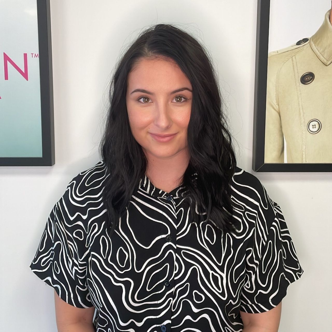 Renee Blackwell from Fusion Hair Cairns - a woman wearing a black and white shirt is smiling