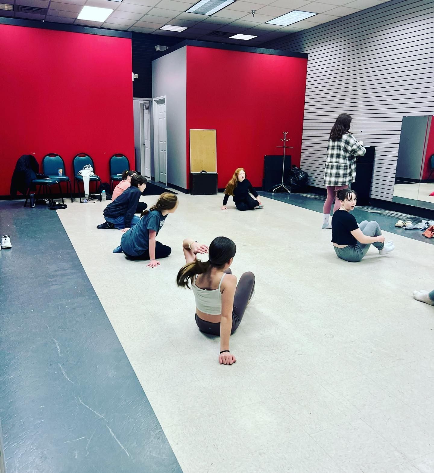 a group of people are sitting on the floor in a dance studio | Buffalo, NY | MEL's School of Music & Theater