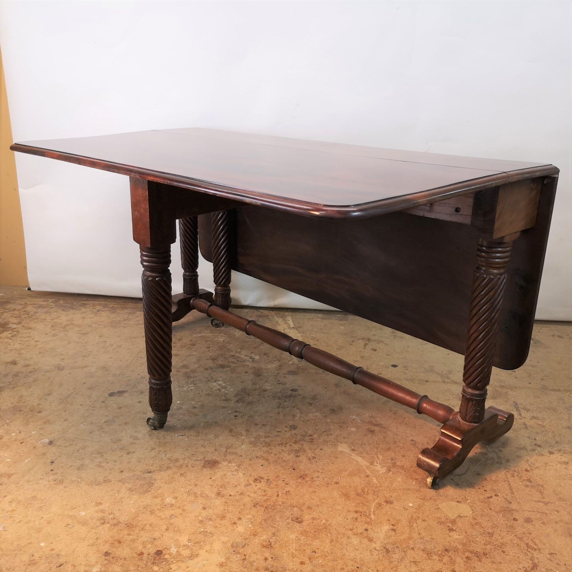 A wooden table is sitting on a concrete floor
