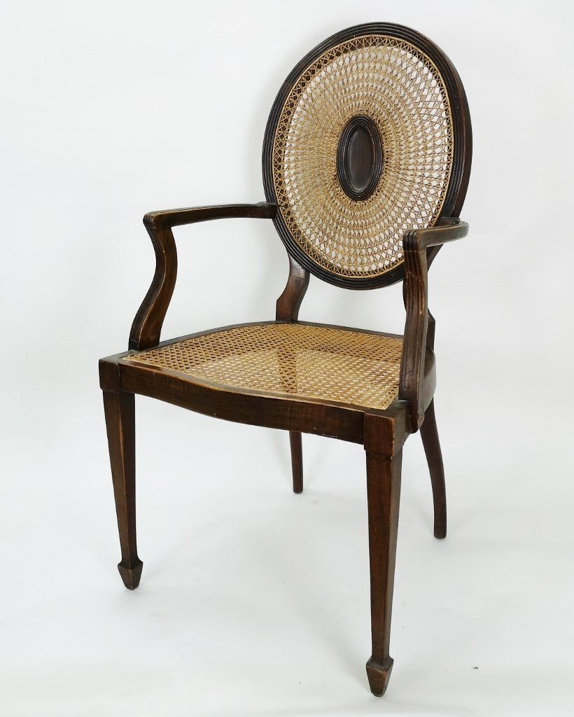 A wooden chair with a wicker seat and back