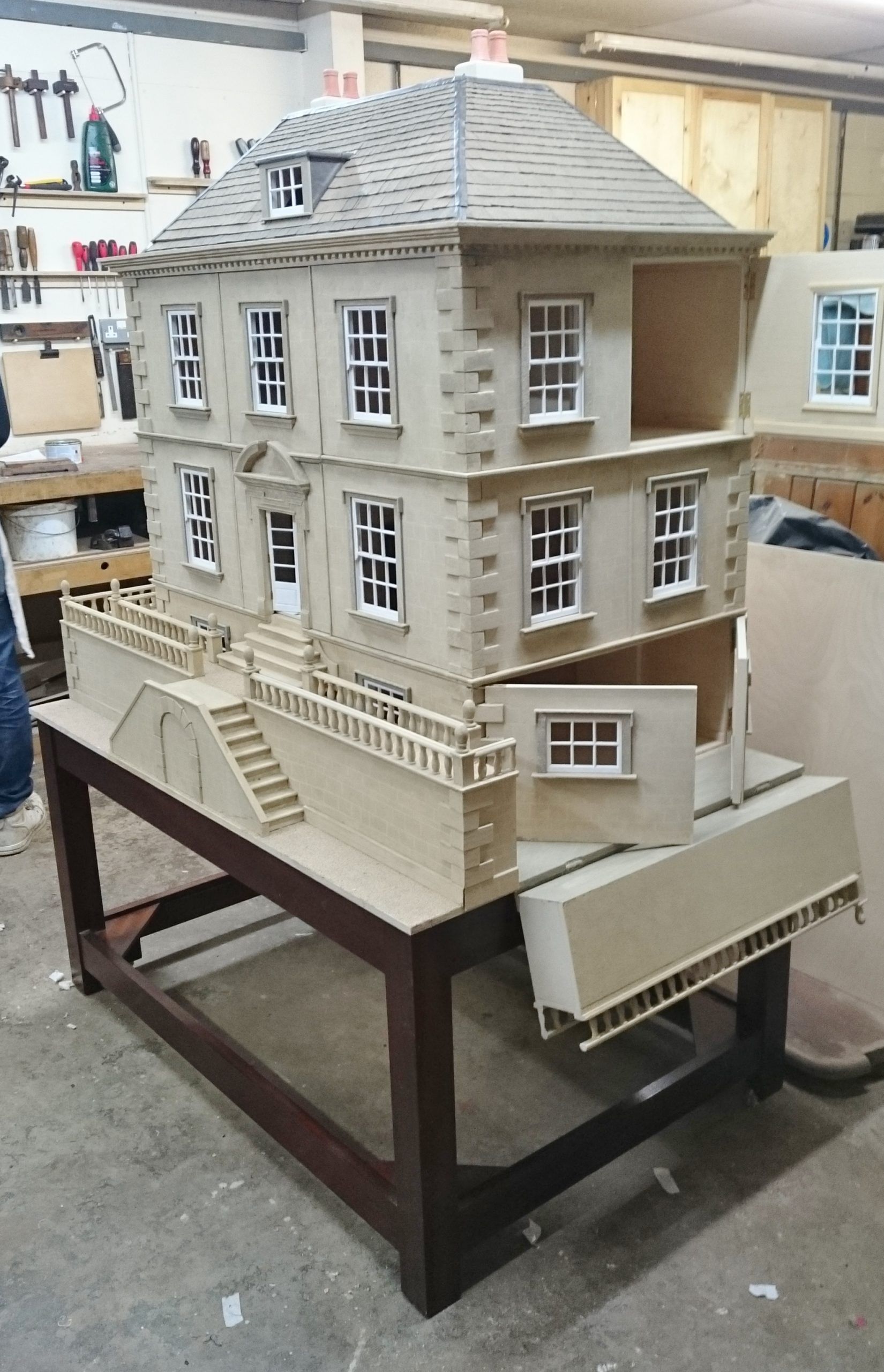 A doll house is sitting on top of a wooden table