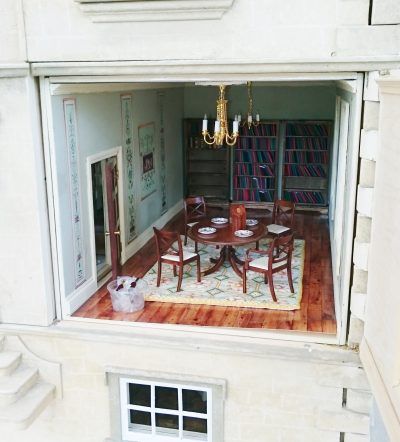An aerial view of a dining room with a table and chairs
