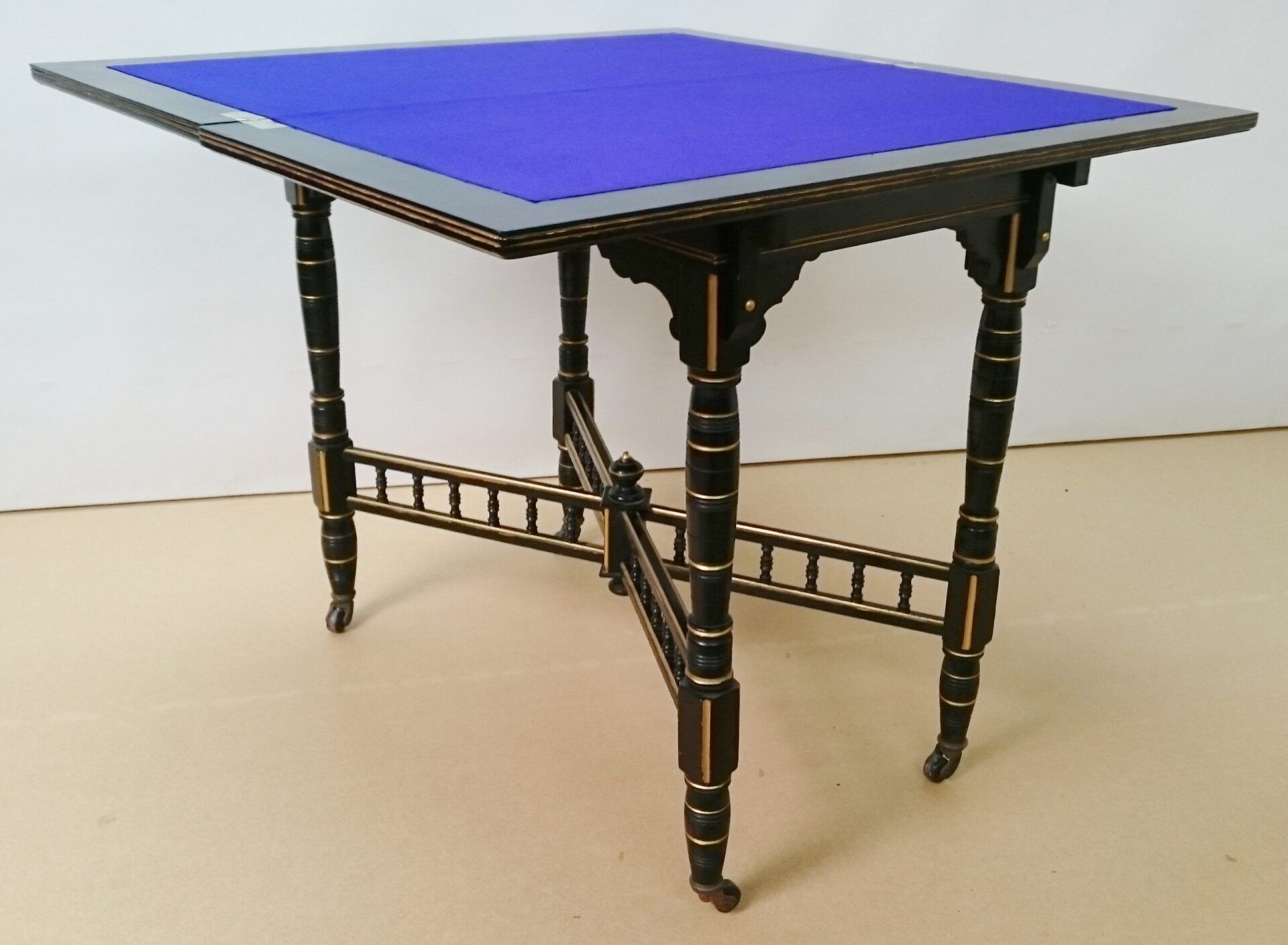A small table with a blue top and black legs