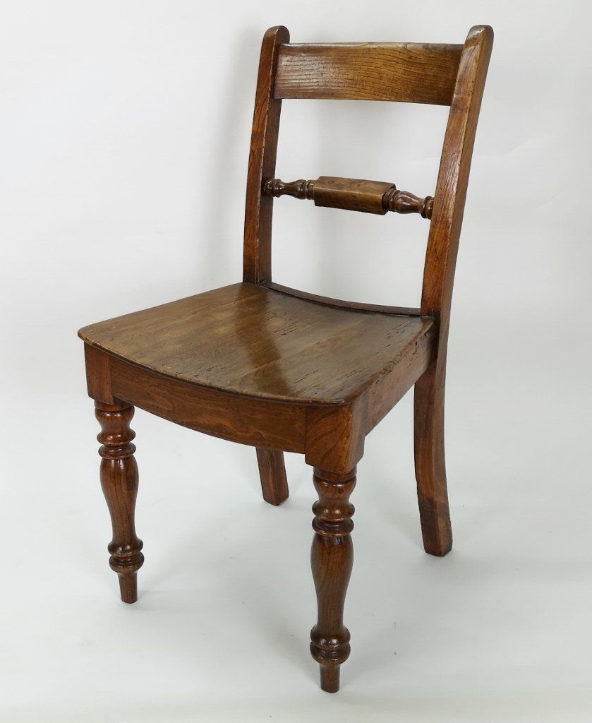 A wooden chair is sitting on a white surface