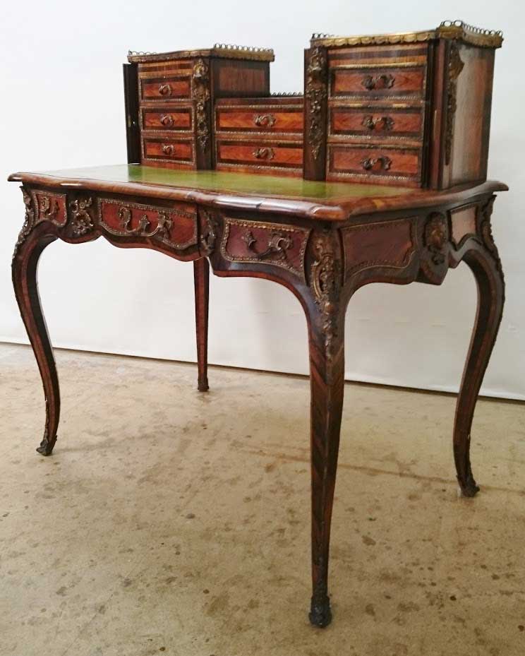 A wooden desk with drawers on top of it