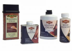A bottle of leather cream , a bottle of ring remover , and a bottle of wood bleacher.