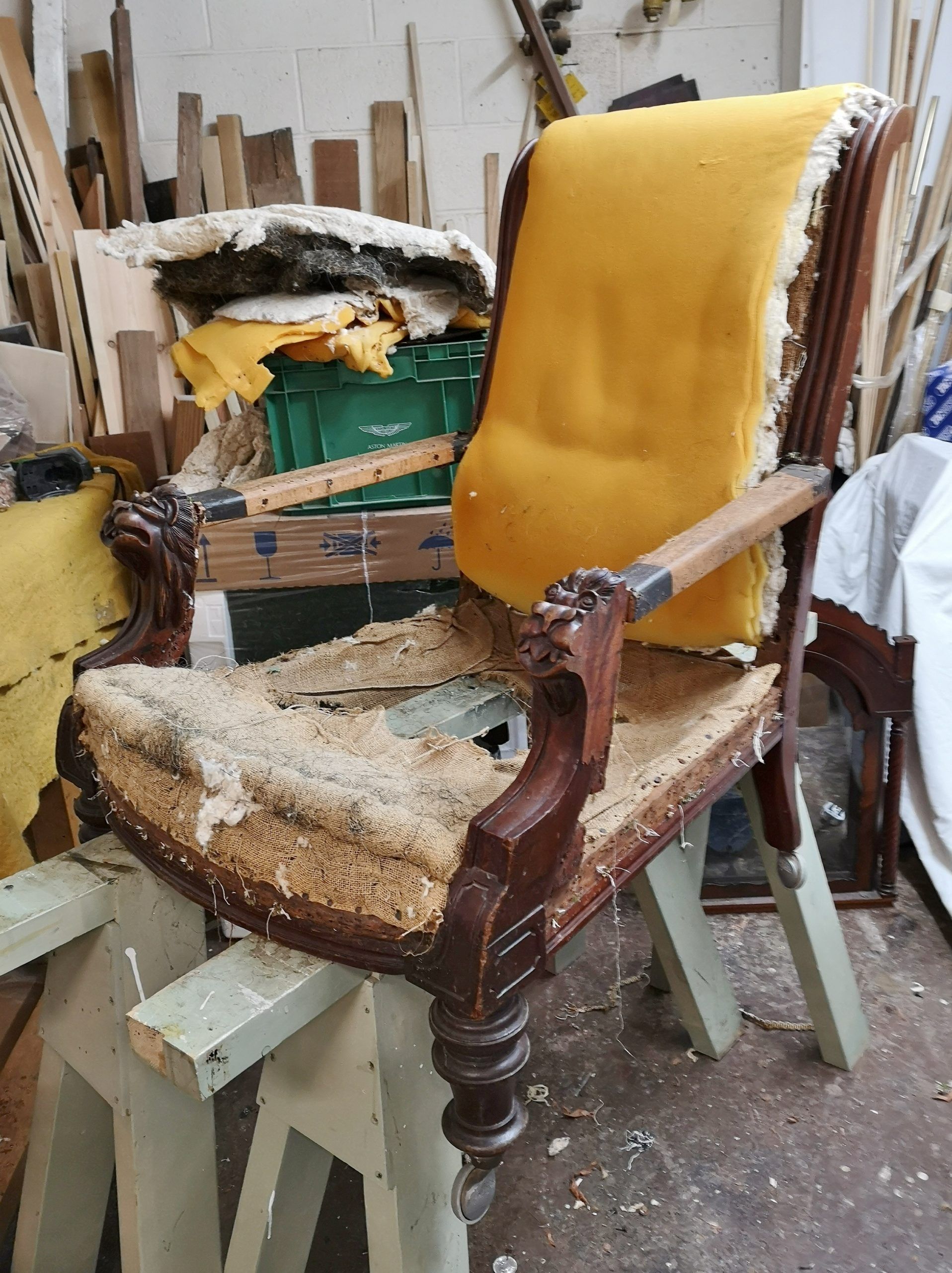 A chair with a yellow cushion is sitting on a wooden table.