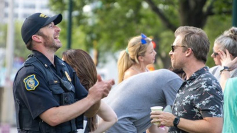 Police officer talking to residents