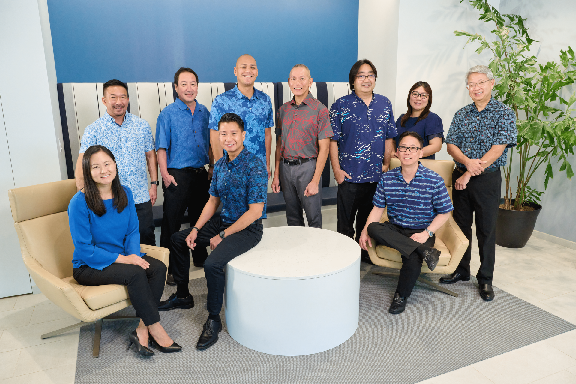 professional accounting principals of N&K CPAs, Inc. sitting in the waiting room wearing blue and white attire in their Downtown Honolulu office