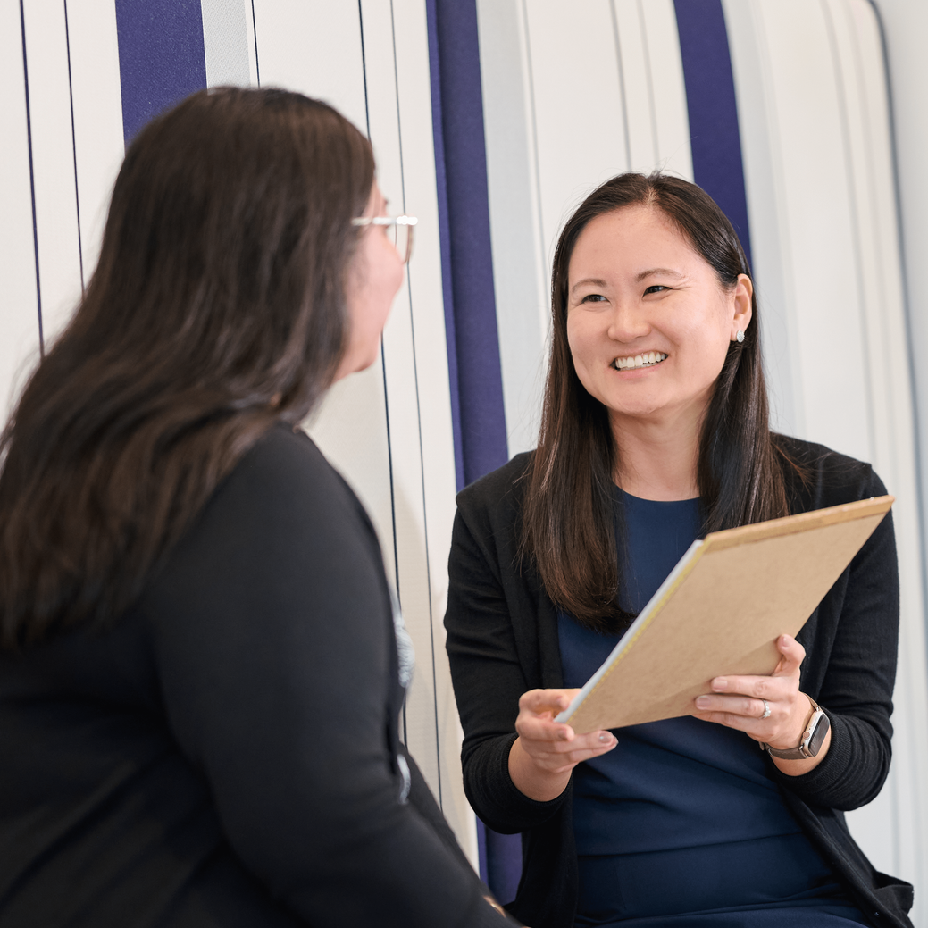 a female accounting expert holds up a folder of information to present to an accounting client at hawaii accountant firm N&K CPAs