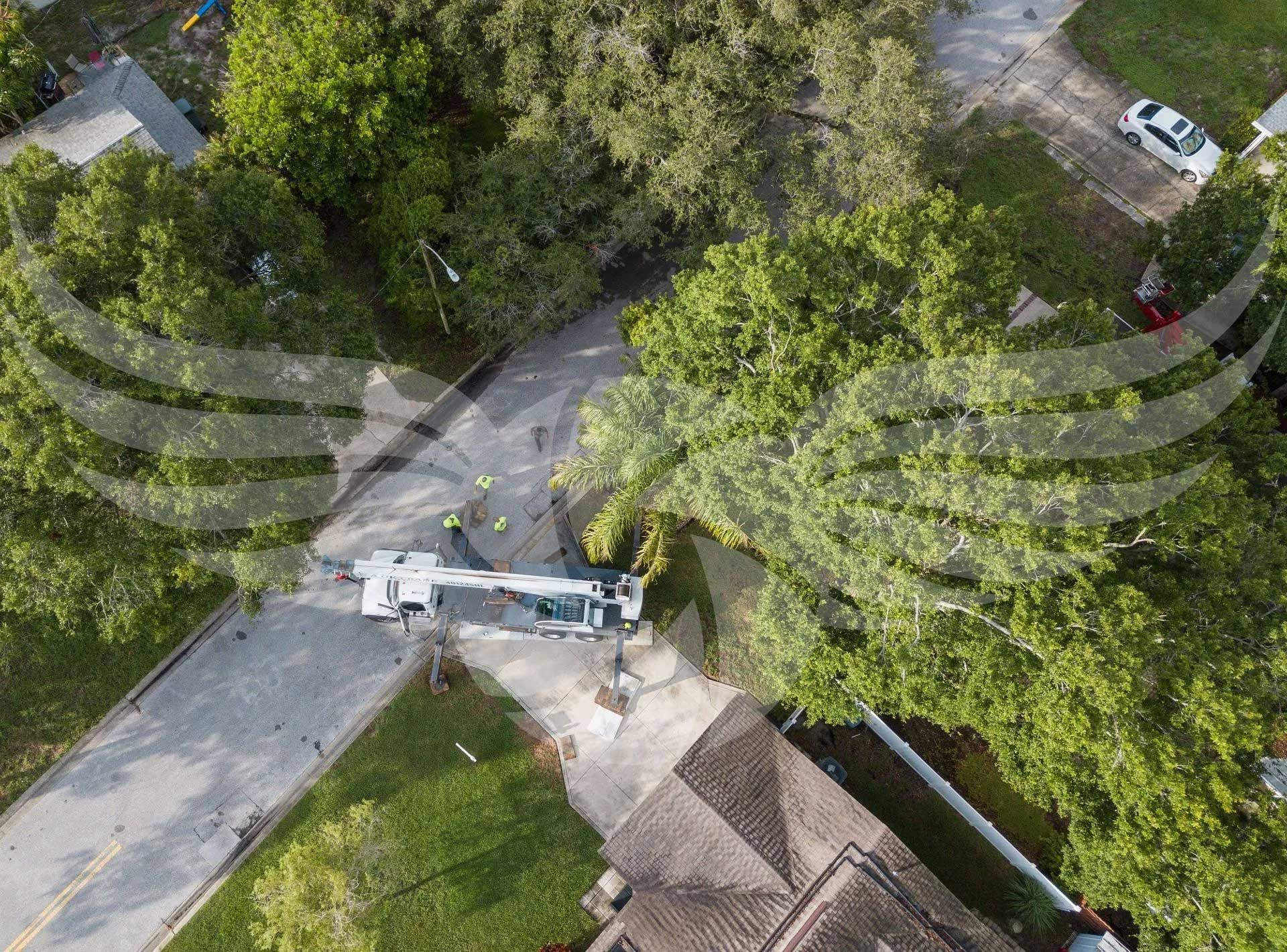 An aerial view of a tree cutting machine in a residential area.