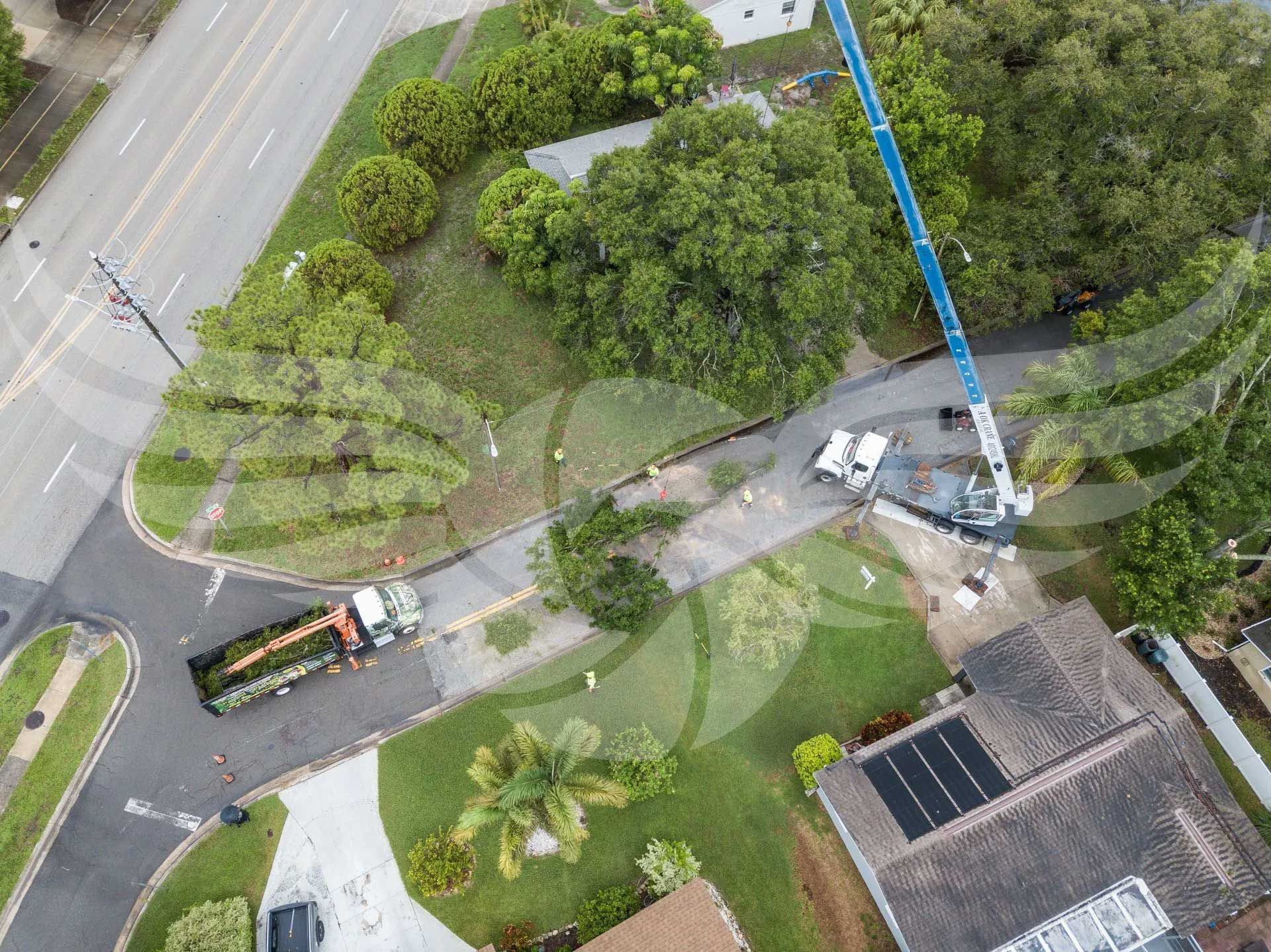 An aerial view of a crane working on a house.