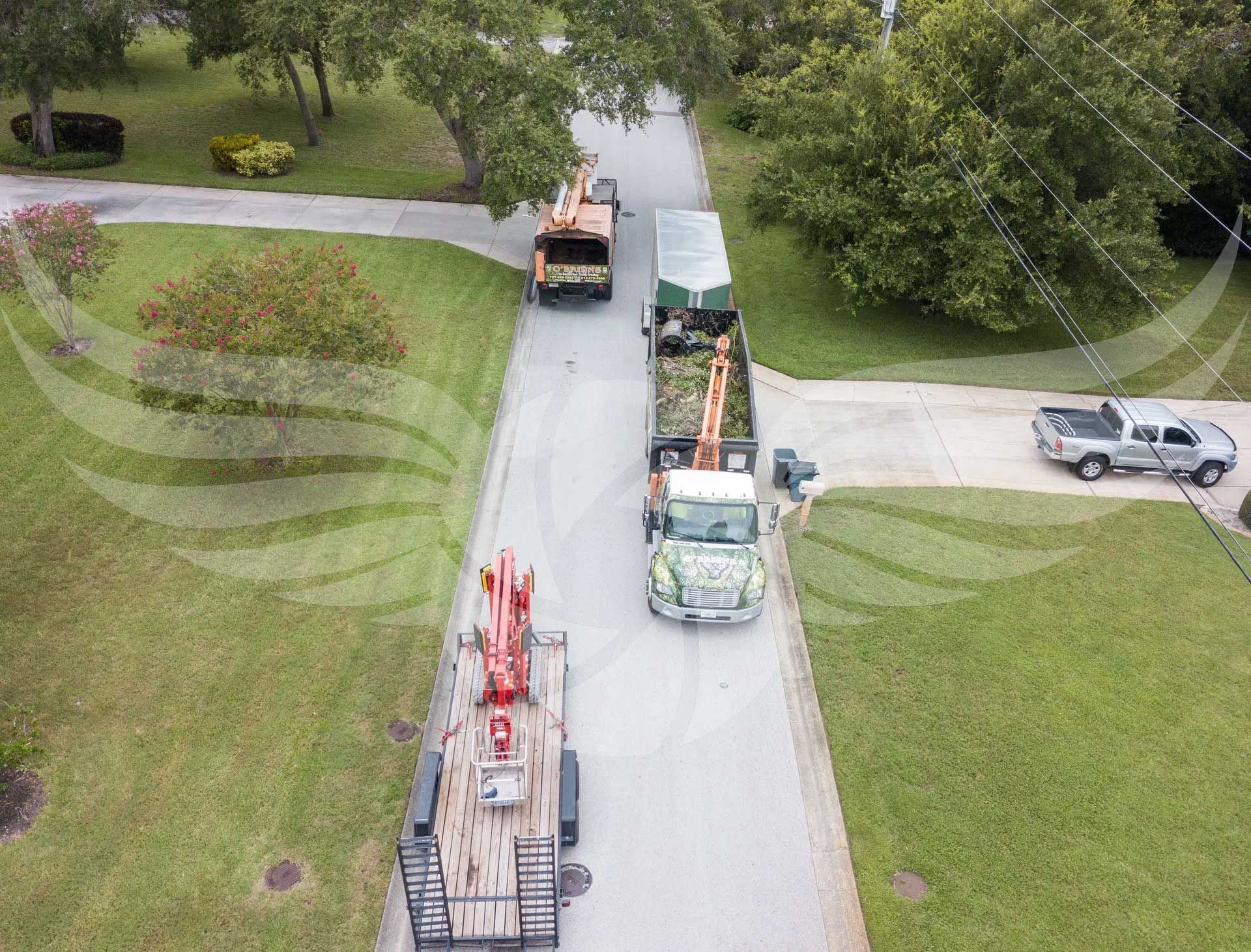An aerial view of three trucks parked on the side of a road.