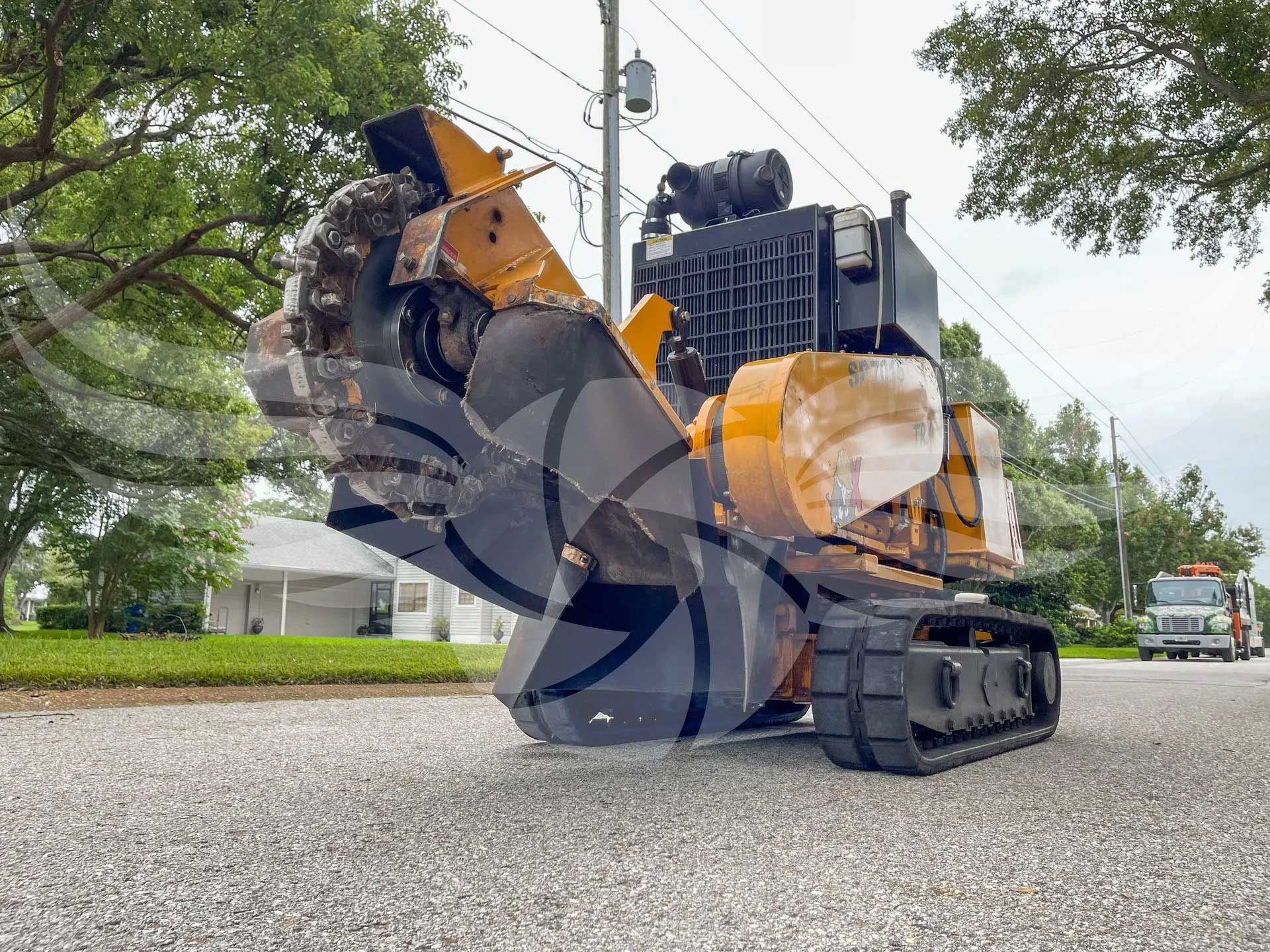 A large machine is sitting on the side of the road.