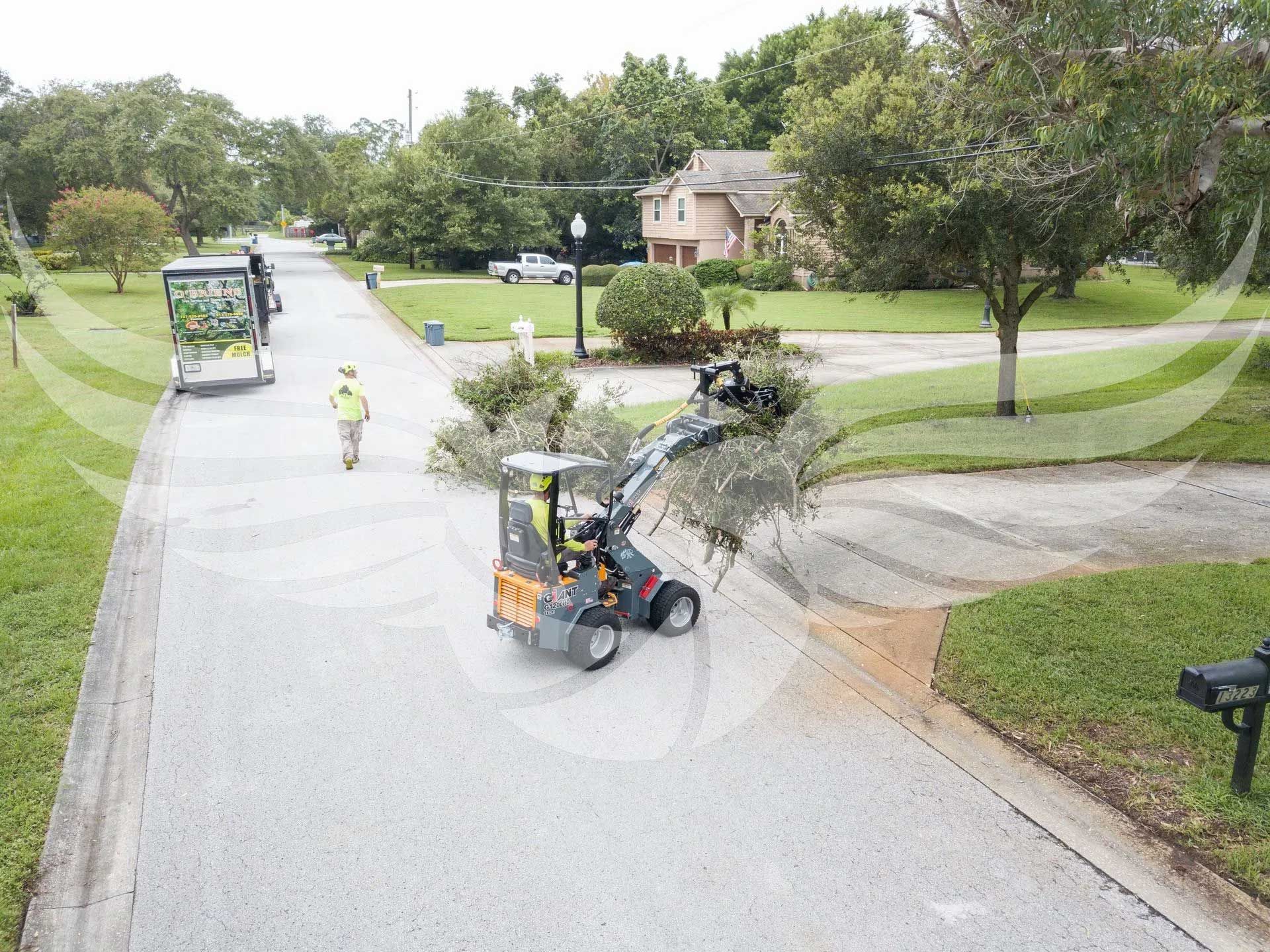 A man is driving a tractor down a street.
