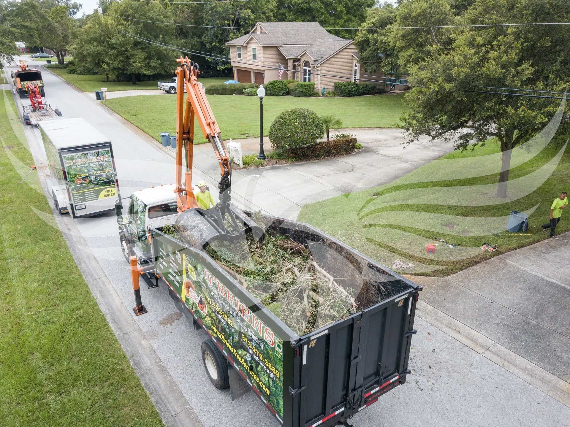 An aerial view of a dump truck with a crane attached to it.
