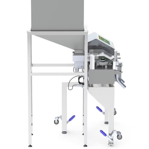 White industrial machine with gray top, on wheeled frame. A gray box sits atop.