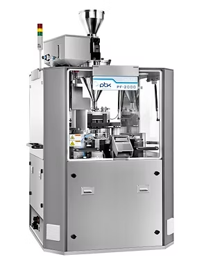 Pharmaceutical capsule filling machine in a clean, industrial setting.