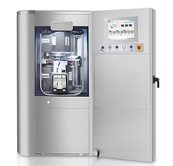 Industrial silver machine with open door, internal components visible, touch screen control panel.