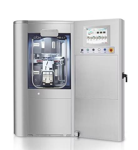 A silver dental milling machine with the door open, displaying internal components and a control panel.