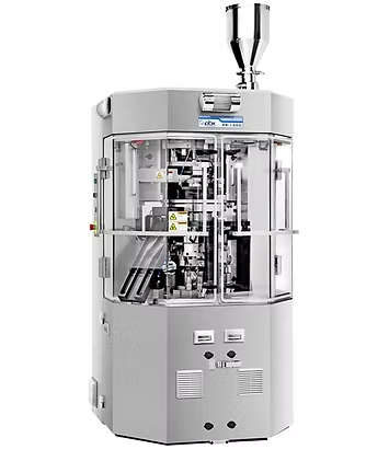 Pharmaceutical capsule filling machine, gray, with a hopper and clear enclosure.