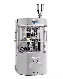 Silver capsule filling machine with clear panels, hopper on top.