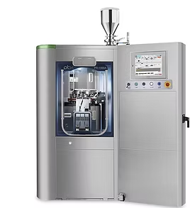 Silver pharmaceutical machine with open door, internal components visible, control panel, and hopper.