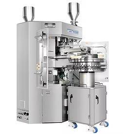 Pharmaceutical capsule filling machine in a clean, industrial setting with silver metal surfaces.