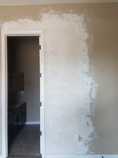 Drywall repair around the door trim, with hawk and trowel texture