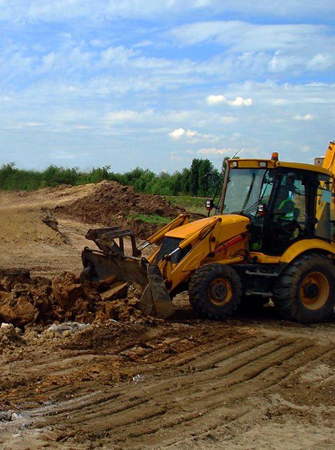 Heavy Equipment — Yellow Backhoe on Construction Site in Canastota, NY