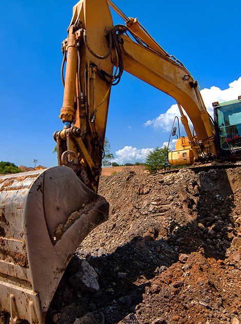 Rasmussen Excavation — Yellow Excavator Moving Soil in Canastota, NY
