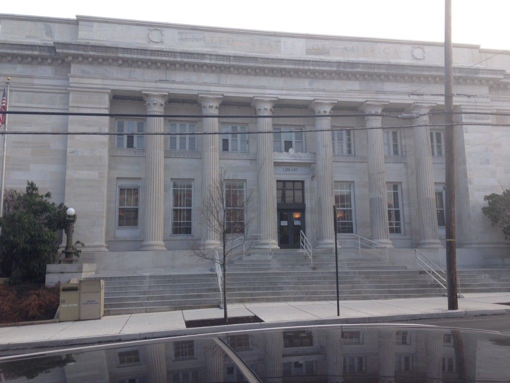 A large building with columns and stairs in front of it