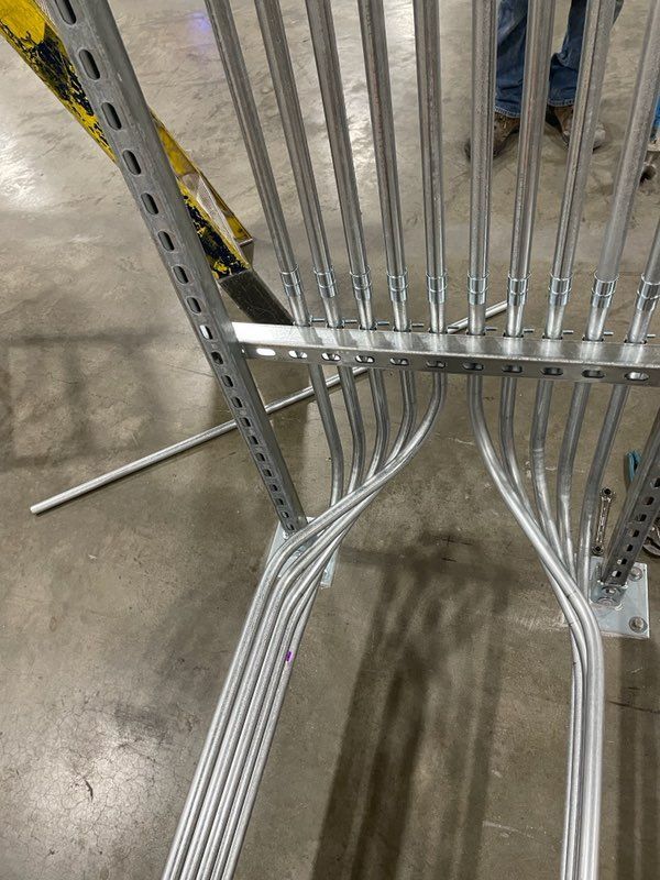 A bunch of metal pipes are connected to each other in a warehouse.