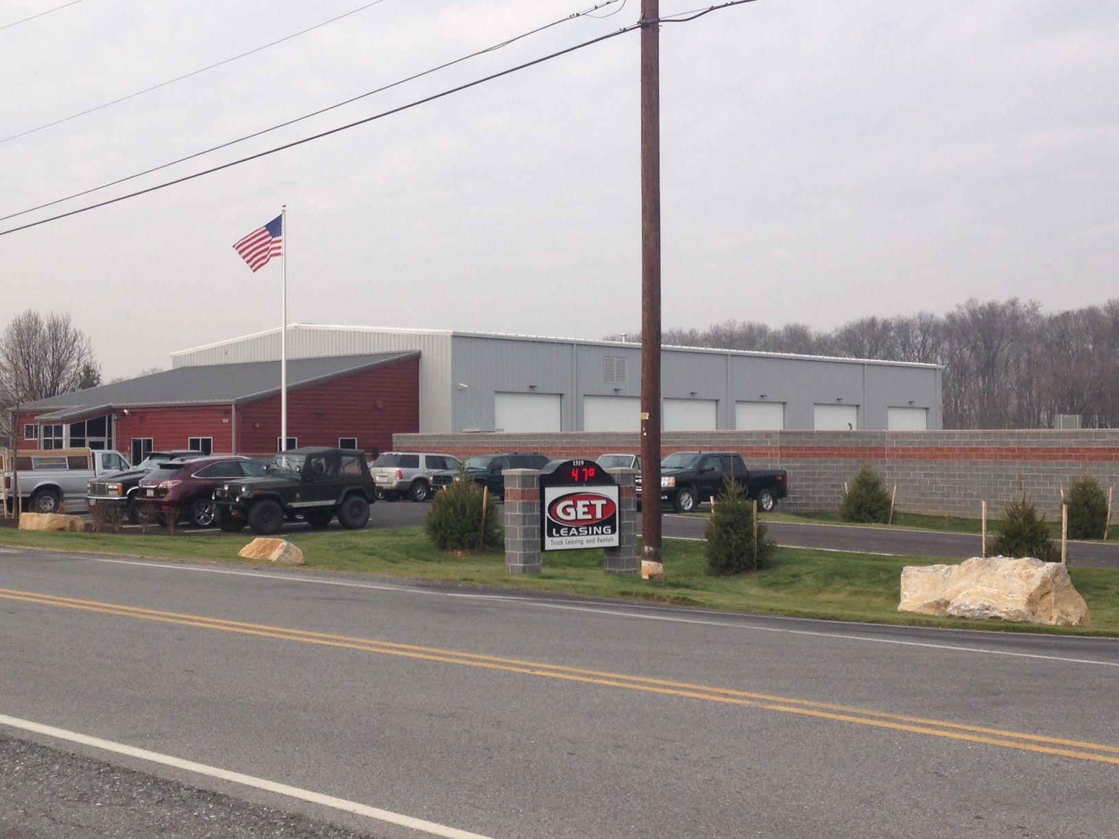 A parking lot with a sign that says ' g & t ' on it