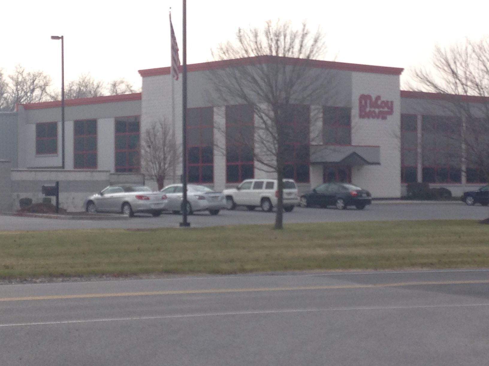 Cars are parked in front of a large white building that says meijer