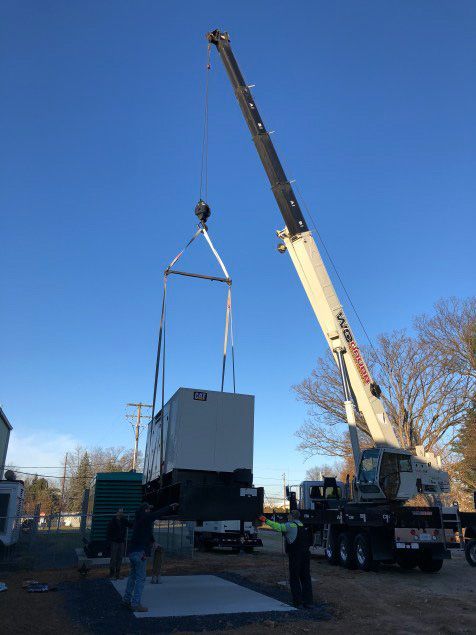 A large crane is lifting a box into the air.