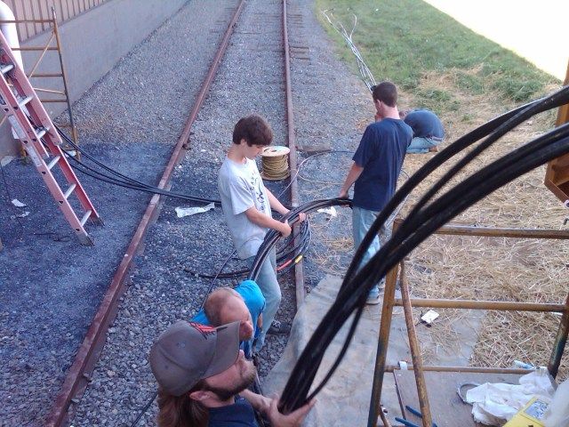 A group of people are working on a train track