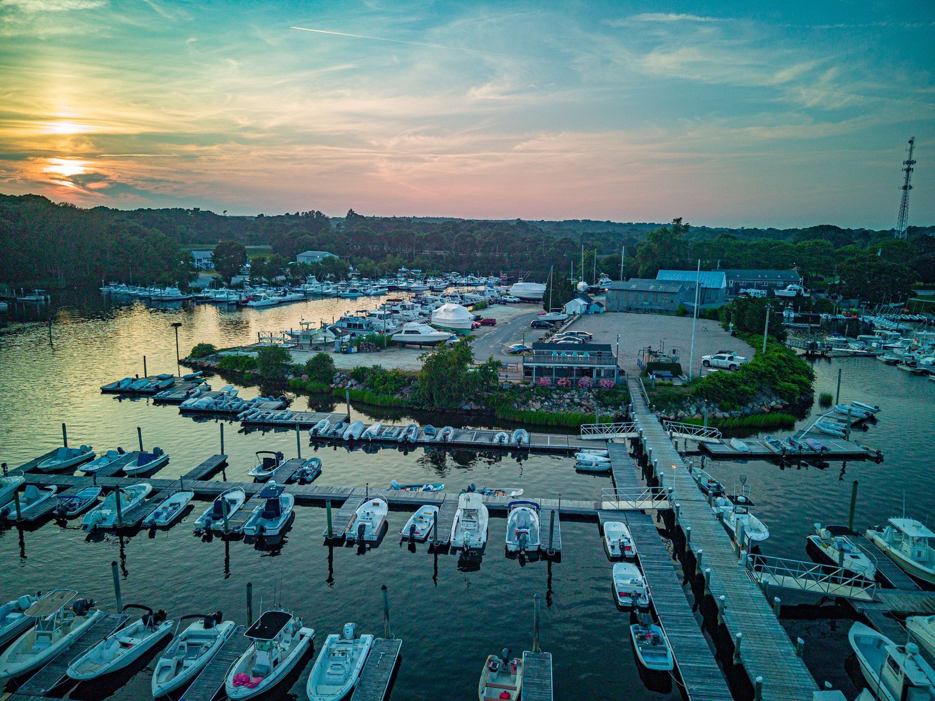 An aerial view of a marina with boats docked at sunset.