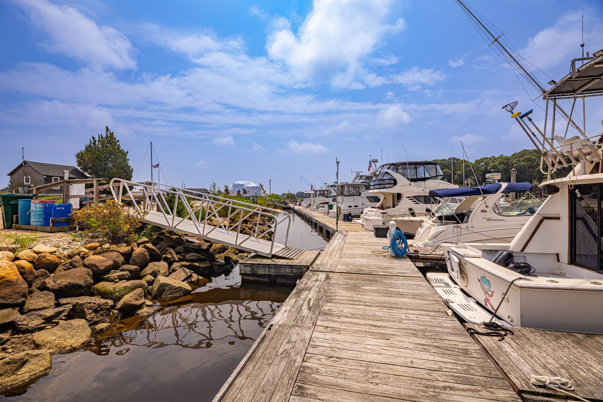 A boat is docked at a dock next to a body of water.