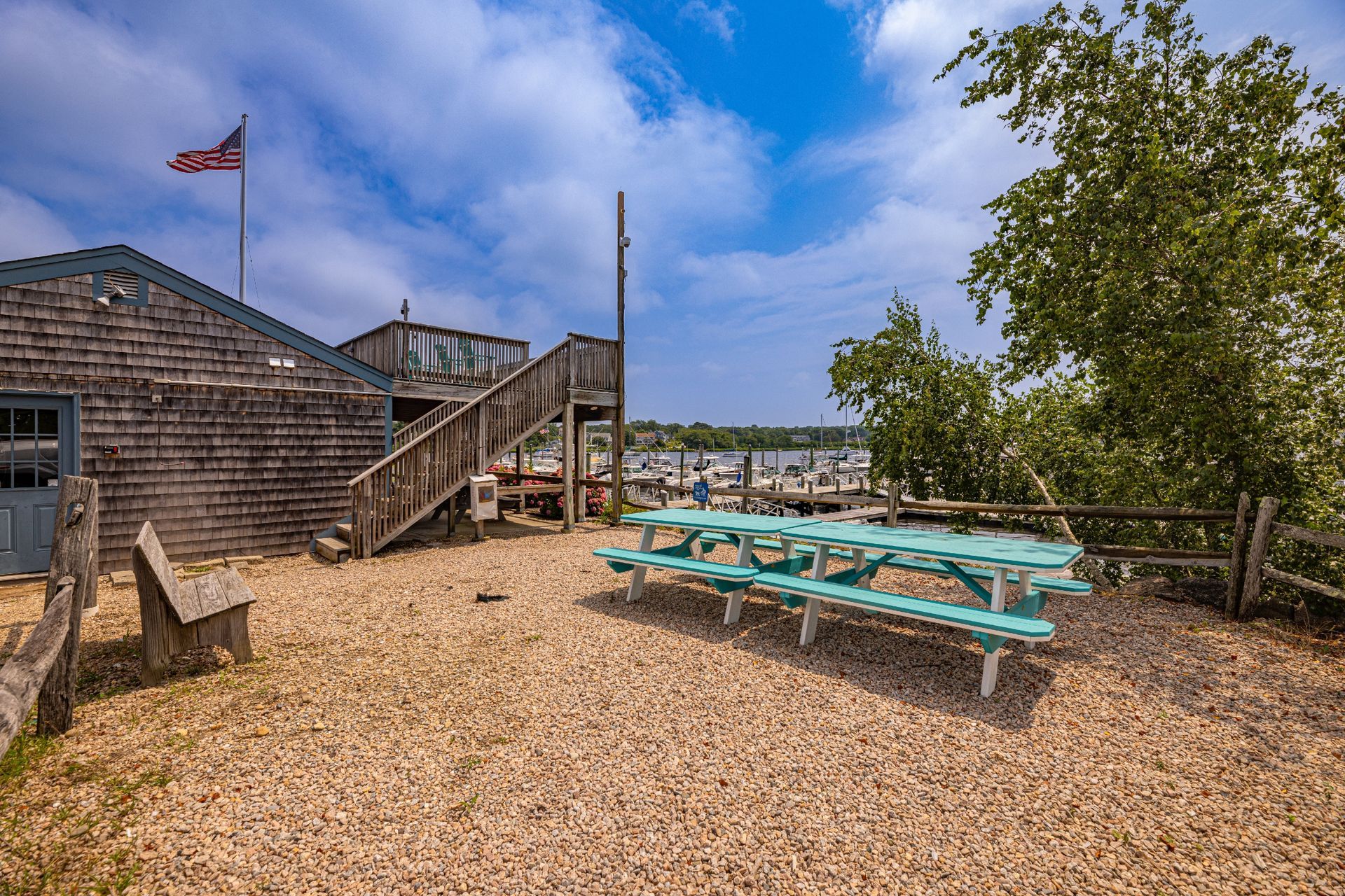 A picnic table is sitting in the dirt in front of a building.