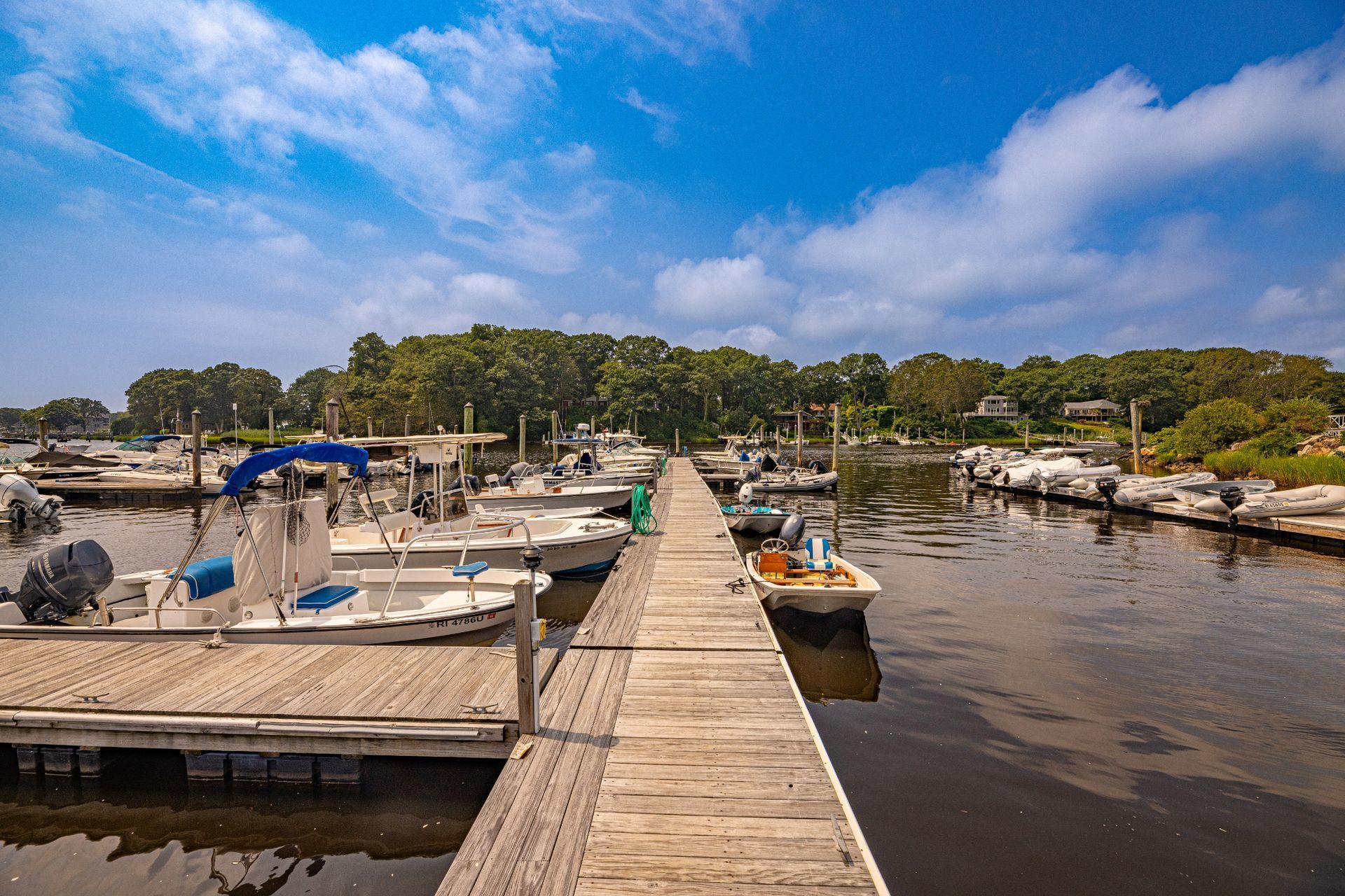 A dock with boats docked at the end of it